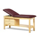 a classic medical table with shelf,  burgundy upholstery and natural base color