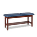 a classic medical table with shelf,  royal blue upholstery and dark cherry base color