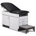 A medical examination table with drawers and patient step stool, black upholstery and gray base color