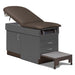 A medical examination table with drawers and patient step stool, gunmetal upholstery and slate gray base color