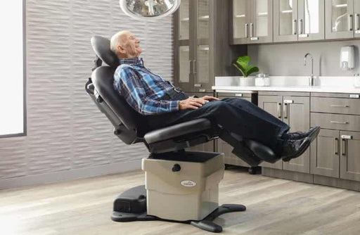 old man sitting in a black medical chair